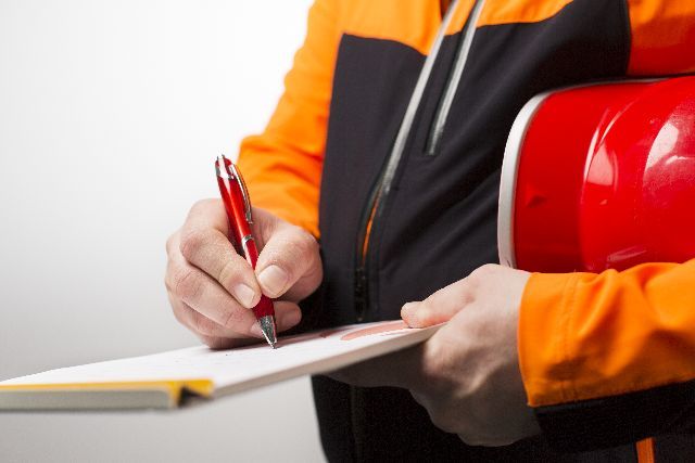 Hand, die eine Checkliste ausfüllt